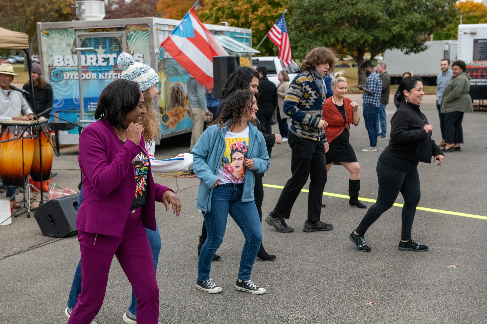 A group of people salsa on the pavement at the Food Truck Fiesta for Marshall Space Flight Center's Hispanic Heritage Month celebration. 