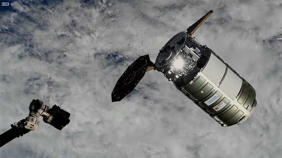 Northrop Grumman's Cygnus space freighter approaches the space station moments before being captured with the Canadarm2 robotic arm (bottom left). Credit: NASA TV