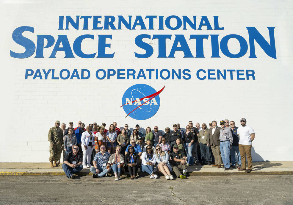A group participating in the Heroes Week Tour at NASA’s Marshall Space Flight Center pauses for a photo at the Payload Operations Center on Nov. 9. 