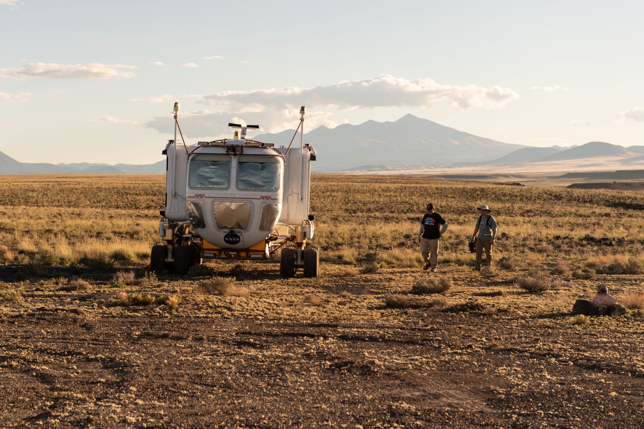 D-RATS crew inside the pressurized rover practice driving along the traverse with covered windows, relying on views from outside cameras.