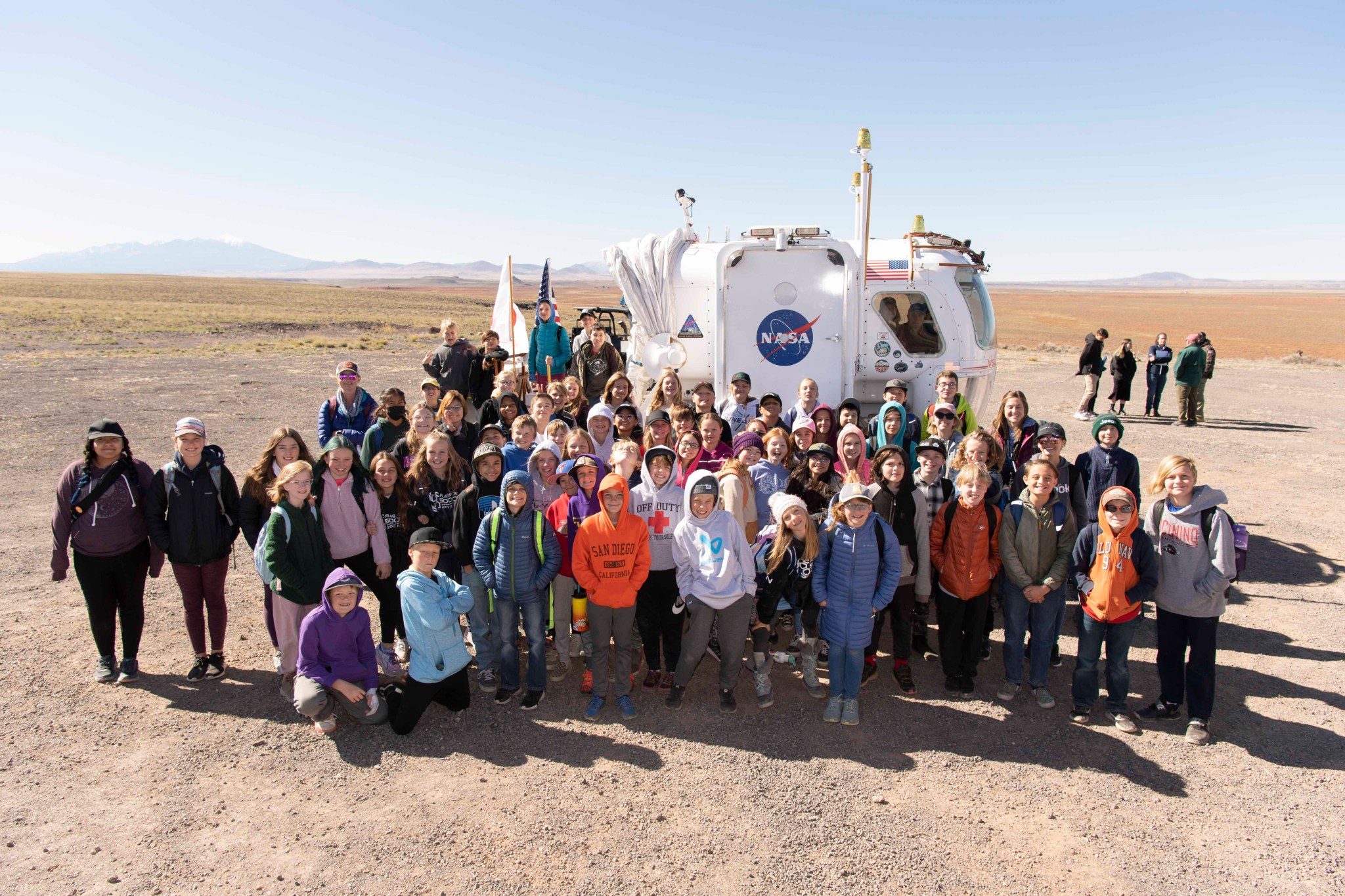 Students from Sinagua Middle School in Flagstaff, Arizona, pose in front of the rover during D-RATS media and outreach day.