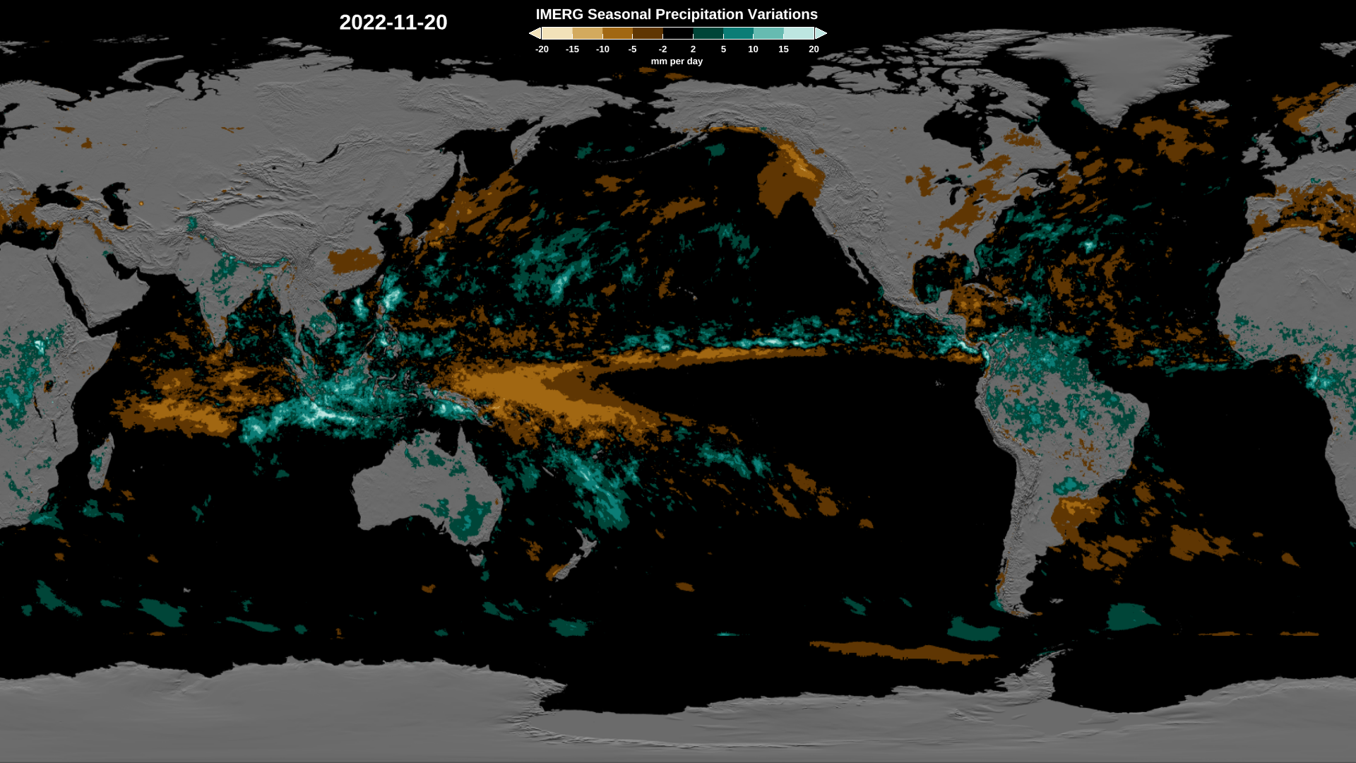 A flat map of the globe, with water in black and continents in grey. On the map are regions of orange and brown, where precipitation is less than normal for the season; and regions of different shades of teal, where seasonal precipitation is greater .