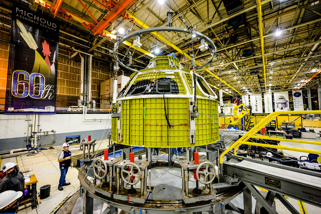 A 60th anniversary banner hangs to the left of an Orion Space craft module at the Michoud Assembly Facility in New Orleans in 2021.