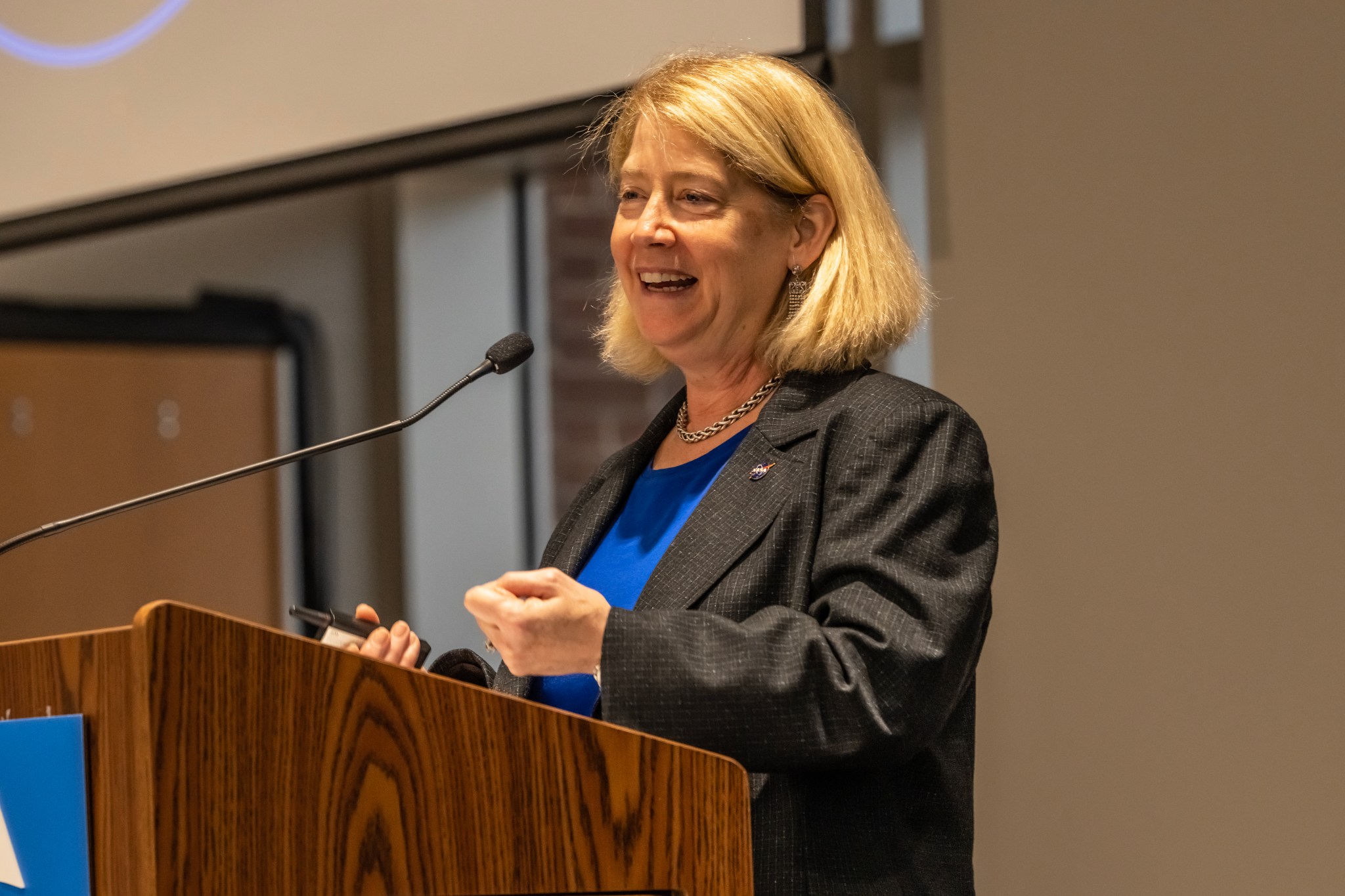 NASA Deputy Administrator Pam Melroy stands at a podium giving a keynote presentation.