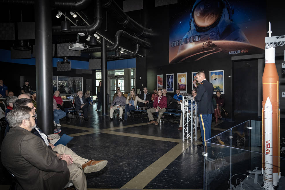 Program attendees listen to Redstone Arsenal Garrison Commander Col. Brian Cozine's presentation. 