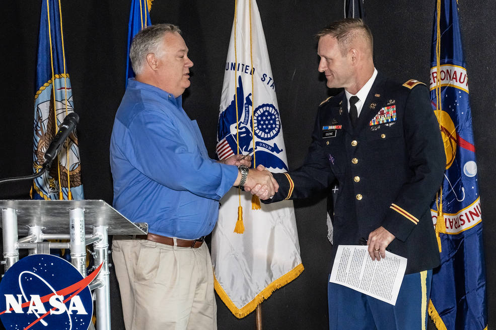 Wes Brown, left, manager of the Office of Strategy at NASA’s Marshall Space Flight Center, greets Redstone Arsenal Garrison Commander Col. Brian Cozine.