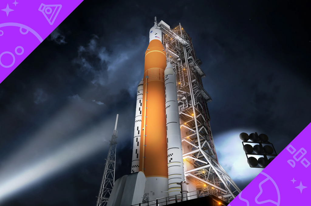 Artemis I sits on the launch pad at night, illuminated by lights