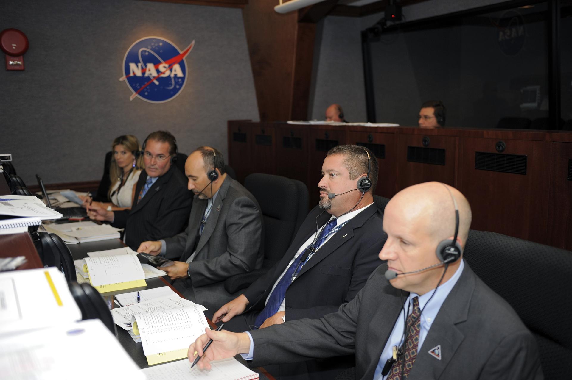 Omar Baez, second from right, GRAIL assistant launch director, Launch Services Program, monitors the launch countdown from the Mission Directors Center in Hangar AE on Cape Canaveral Air Force Station in Florida on Sept. 8, 2011.