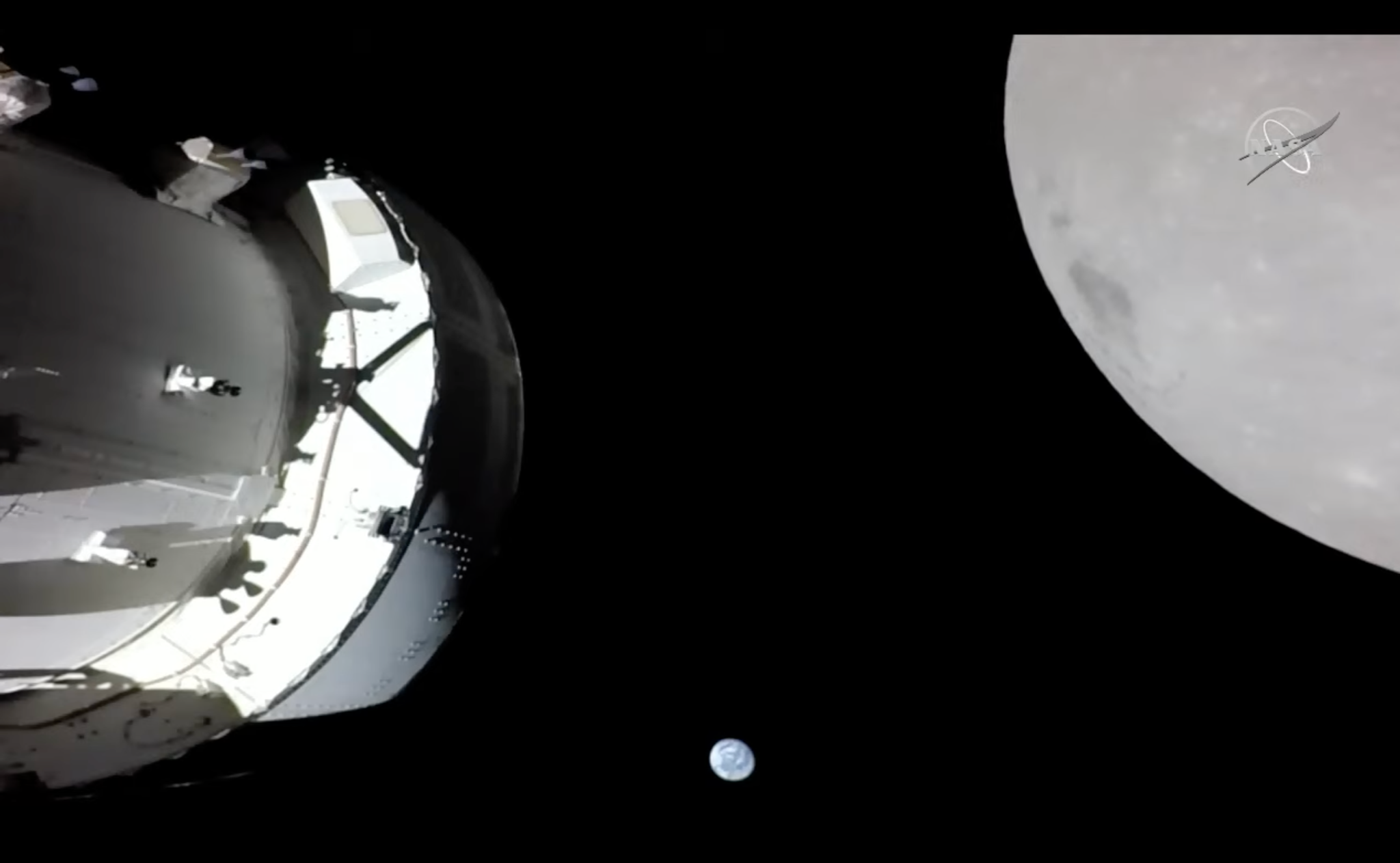 On Nov. 21, 2022, a camera on the Orion's solar array wing camera captured this view of the spacecraft, the Earth and the Moon.