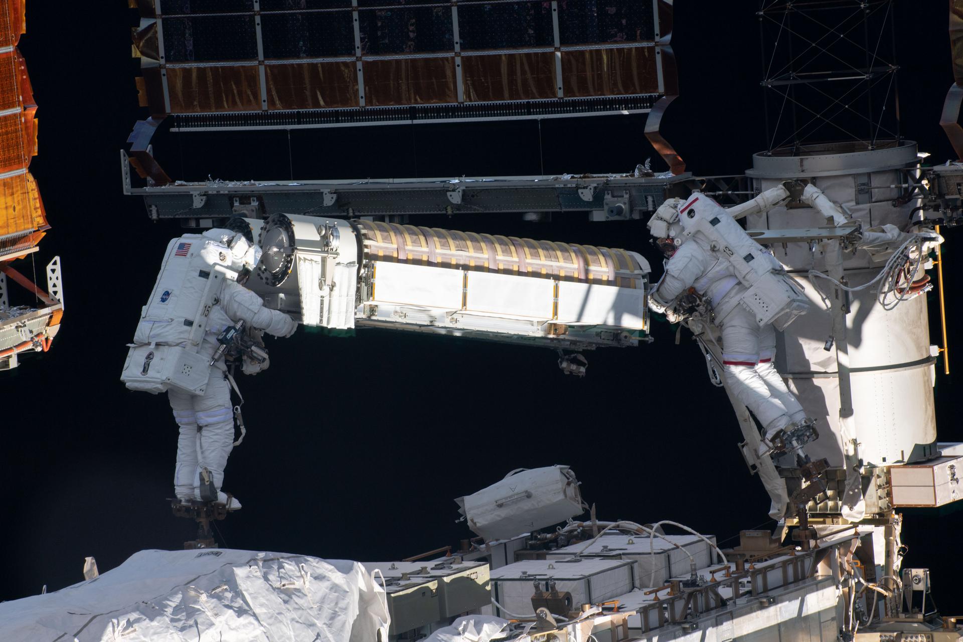 NASA astronaut Shane Kimbrough (left) and ESA astronaut Thomas Pesquet (right) photographed on June 16, 2021, while working to install new roll out solar arrays on the International Space Station's P-6 truss structure.