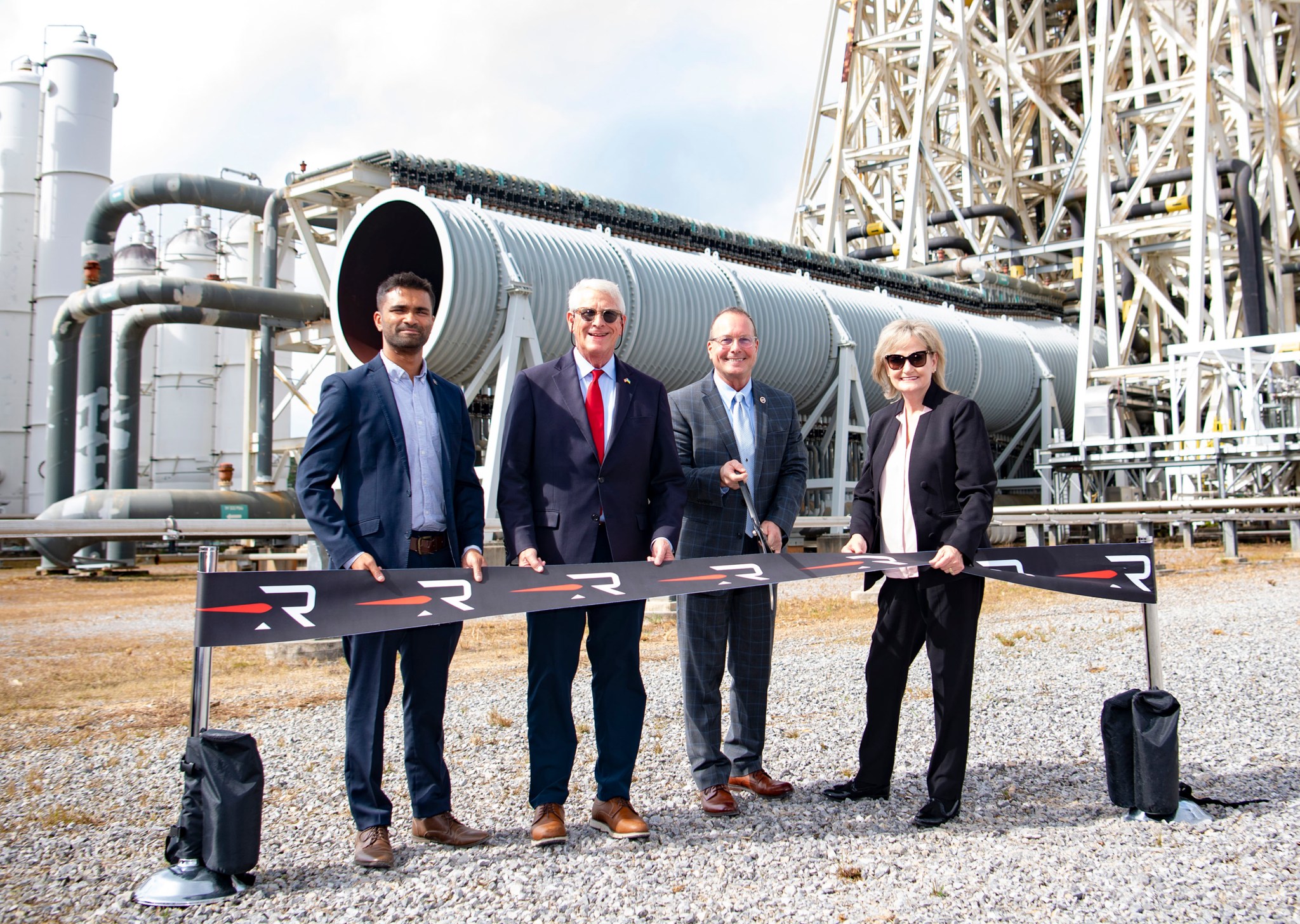 Officials prepare to cut the ribbon during a Nov. 4 ceremony marking an agreement for Rocket Lab USA