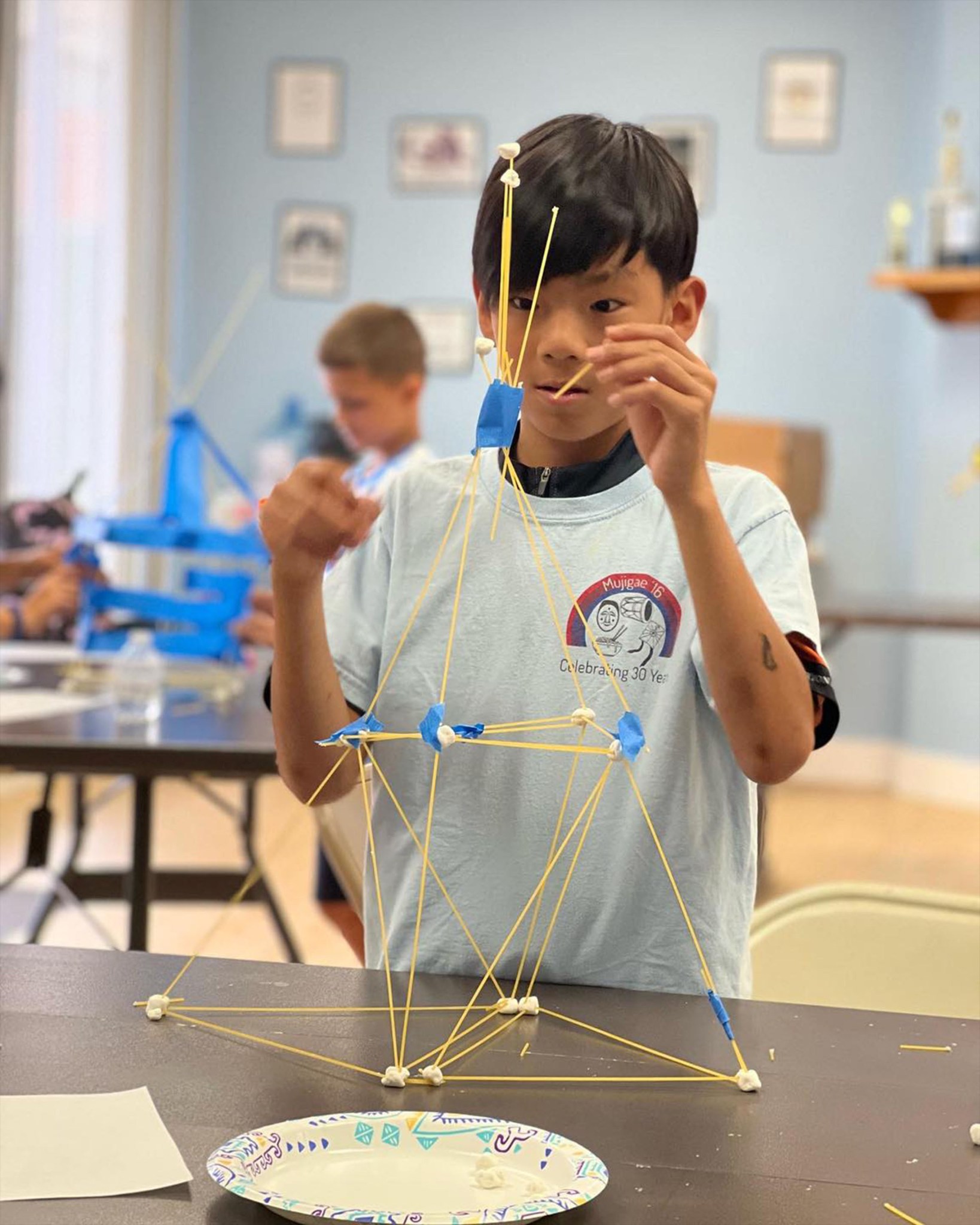 A student focuses on the design of a spaghetti tower at the CT STEM Academy collaborating site in Wallingford, Connecticut, on July 11.