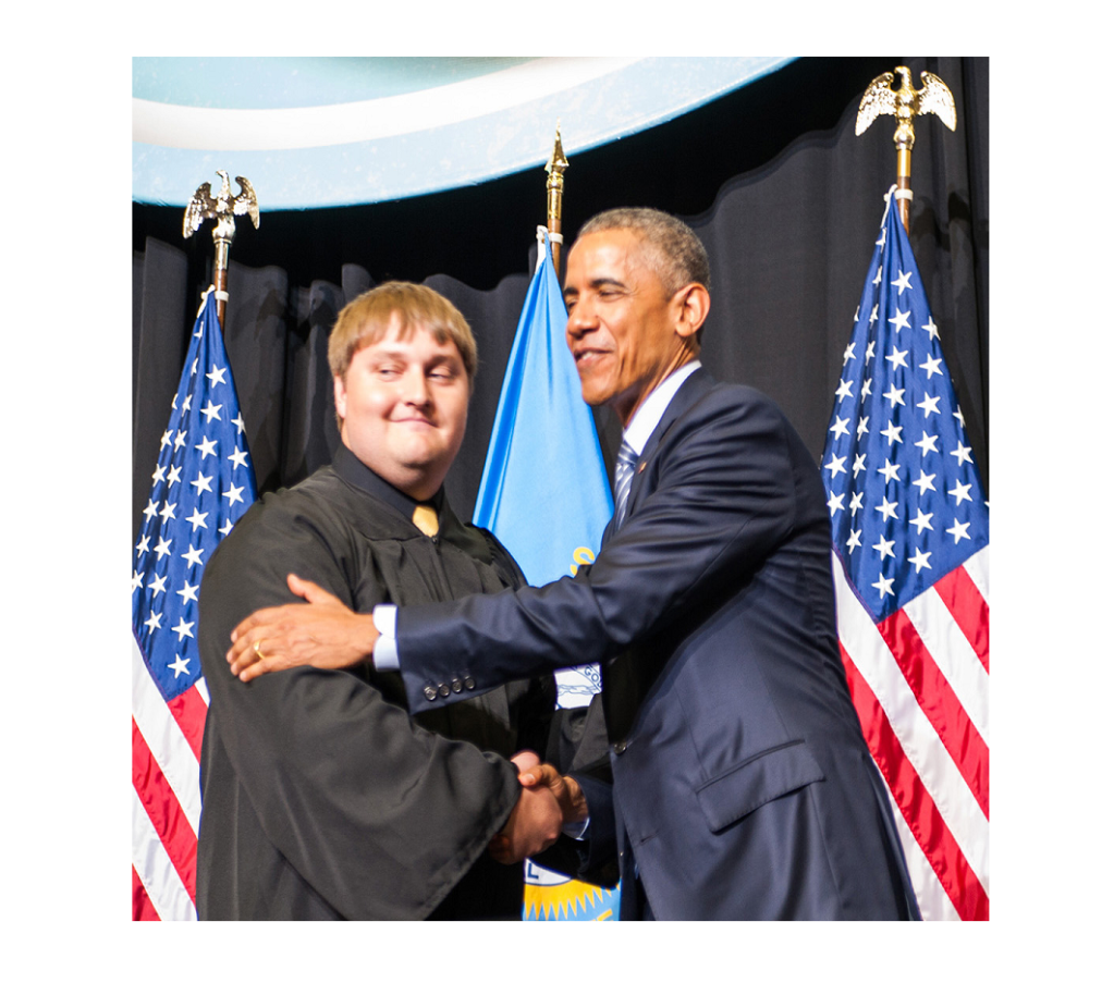 Space Grant student in Graduation Attire Shaking Hands with President Obama