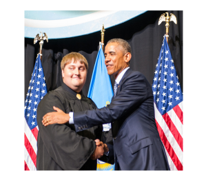 Space Grant student in Graduation Attire Shaking Hands with President Obama