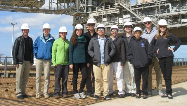 Group of people in hardhats pose for the camera