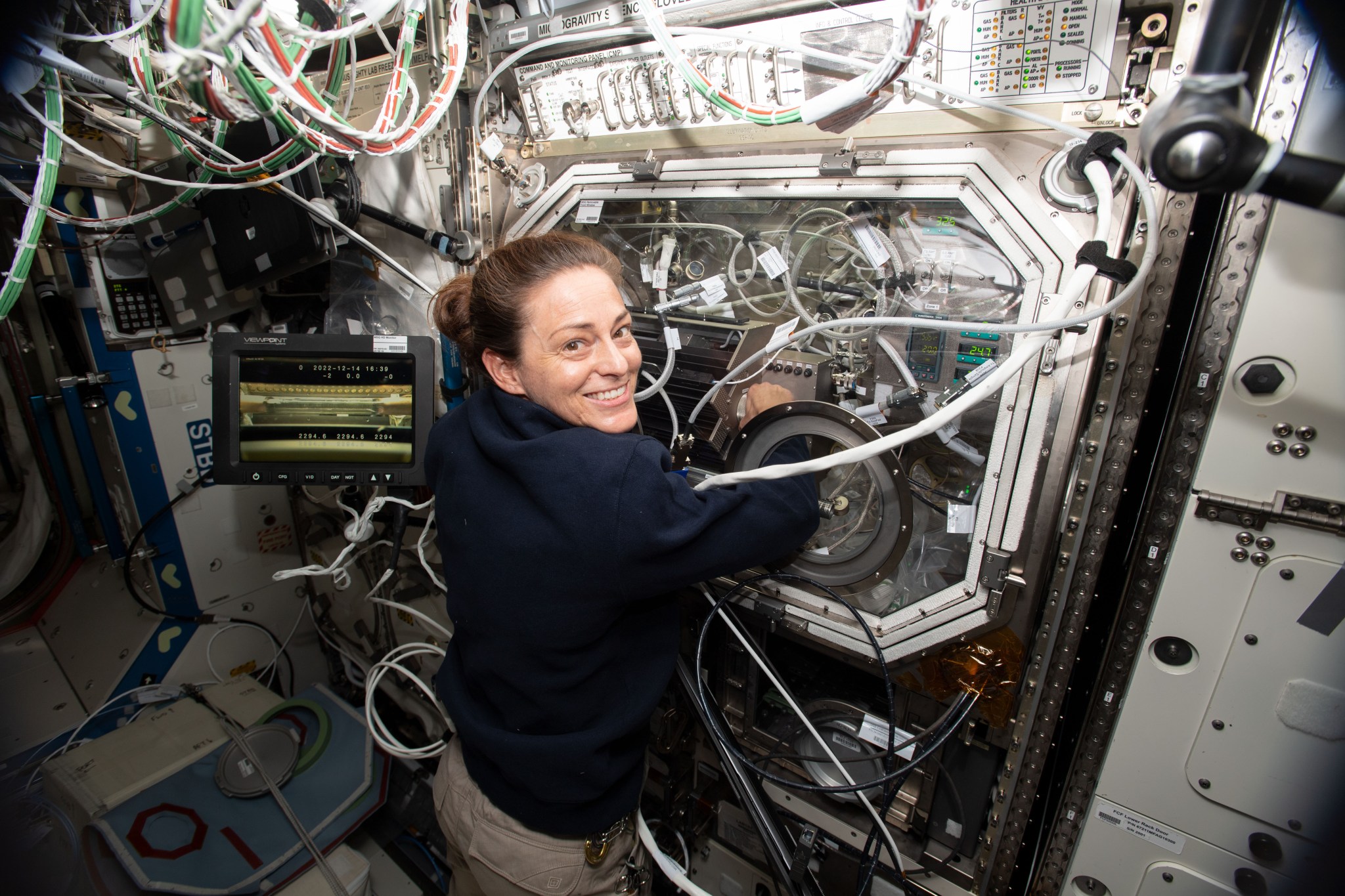 image of an astronaut working with an experiment in a glovebox