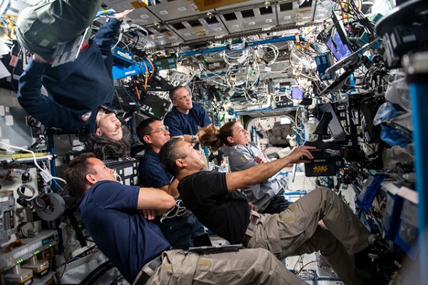 image of expedition 68 crew during a morning meeting in the US Lab of space station