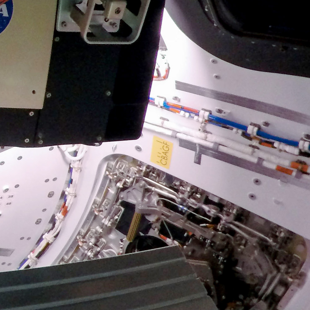 On the starboard or right side of the spacecraft, next to the pilot seat and below one of the windows, are the letters “CBAGF.” 