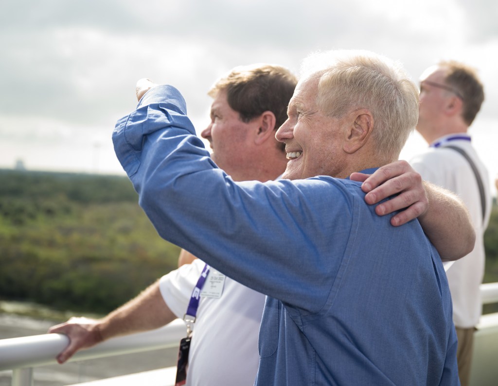 NASA Administrator Bill Nelson and his son Bill Nelson Jr. watch the launch of a SpaceX Falcon Heavy rocket with the Psyche spacecraft onboard from Launch Complex 39A, Friday, Oct. 13, 2023, at NASA’s Kennedy Space Center in Florida.