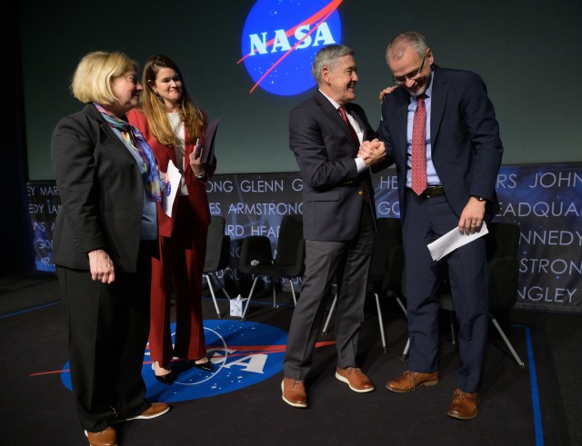 NASA Associate Administrator Bob Cabana, 3rd from left, shakes hands with Incoming NASA Associate Administrator Jim Free, right, as NASA Deputy Administrator Pam Melroy, left, and NASA Deputy Associate Administrator Casey Swails look on at the conclusion of a NASA town hall event, Tuesday, Dec. 12, 2023, at the NASA Headquarters Mary W. Jackson Building in Washington.