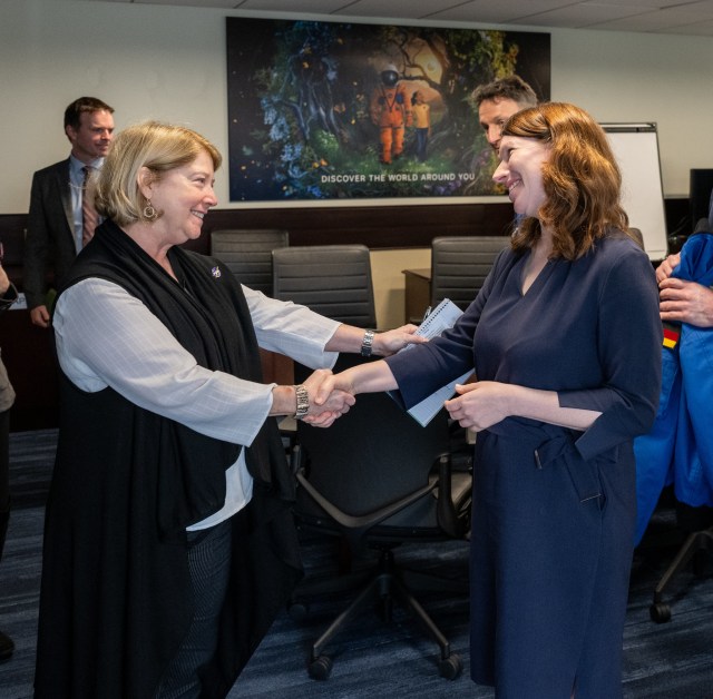 NASA Deputy Administrator Pam Melroy, left, shakes hands with Federal Government Coordinator of German Aerospace Policy Dr. Anna Christmann, right, Thursday, March 7, 2024, at the Mary W. Jackson NASA Headquarters building in Washington.