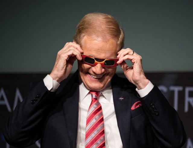 NASA Administrator Bill Nelson tries on some eclipse glasses at the conclusion of a media briefing to discuss the upcoming solar eclipse, Tuesday, March 26, 2024 at the Mary W. Jackson NASA Headquarters building in Washington.