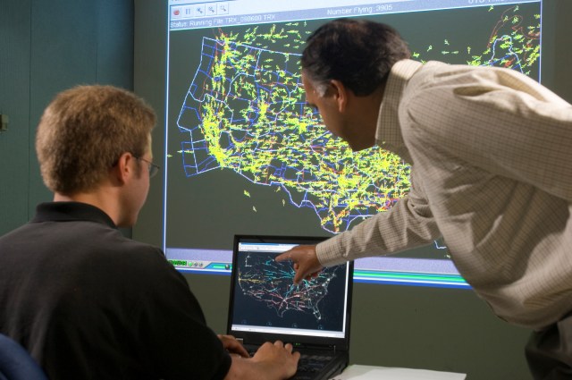 Dr. Shon Grabbe and Kapil Sheth looking at a monitor.