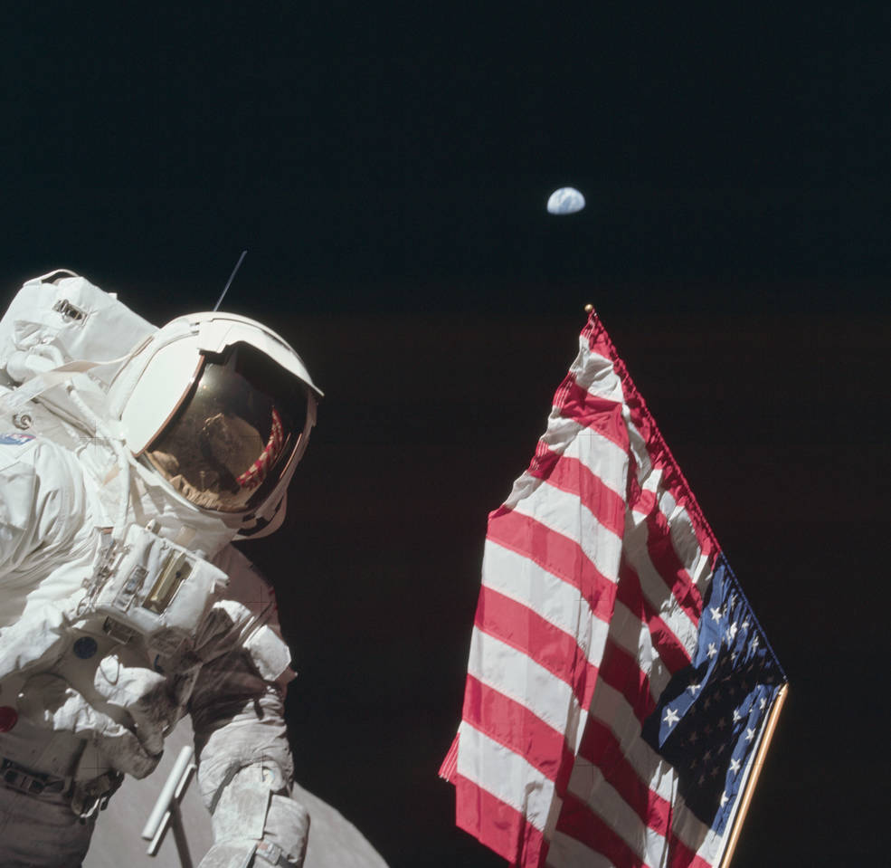 apollo_17_moon_landing_eva1_schmitt_w_us_flag_earth