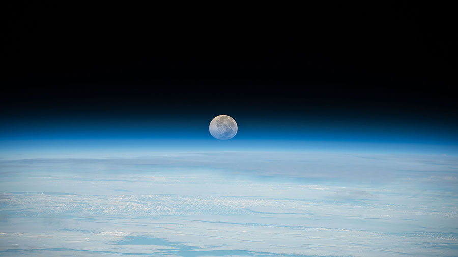 The Full Moon sets below Earth's horizon in this photograph from the space station. The Artemis I mission was about 207,200 miles from Earth and 180,400 miles from the Moon, cruising at 1,415 mph.
