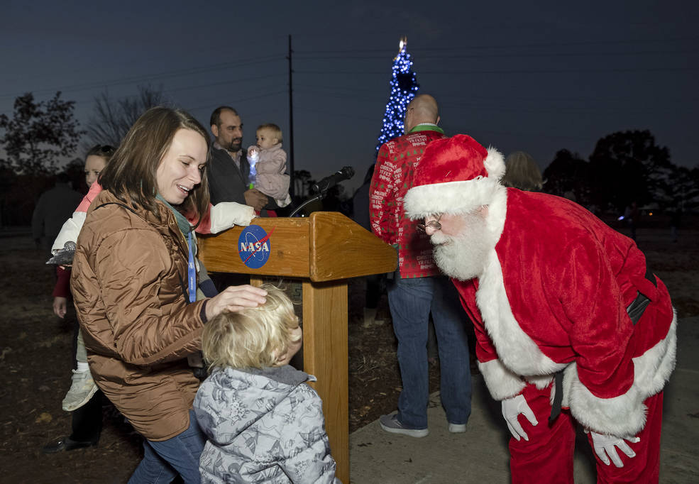 Santa Claus visits with Marshall project manager Michelle Tillotson Rudd and her son, Lyal Rudd, during the annual tree lighting event Dec. 1.