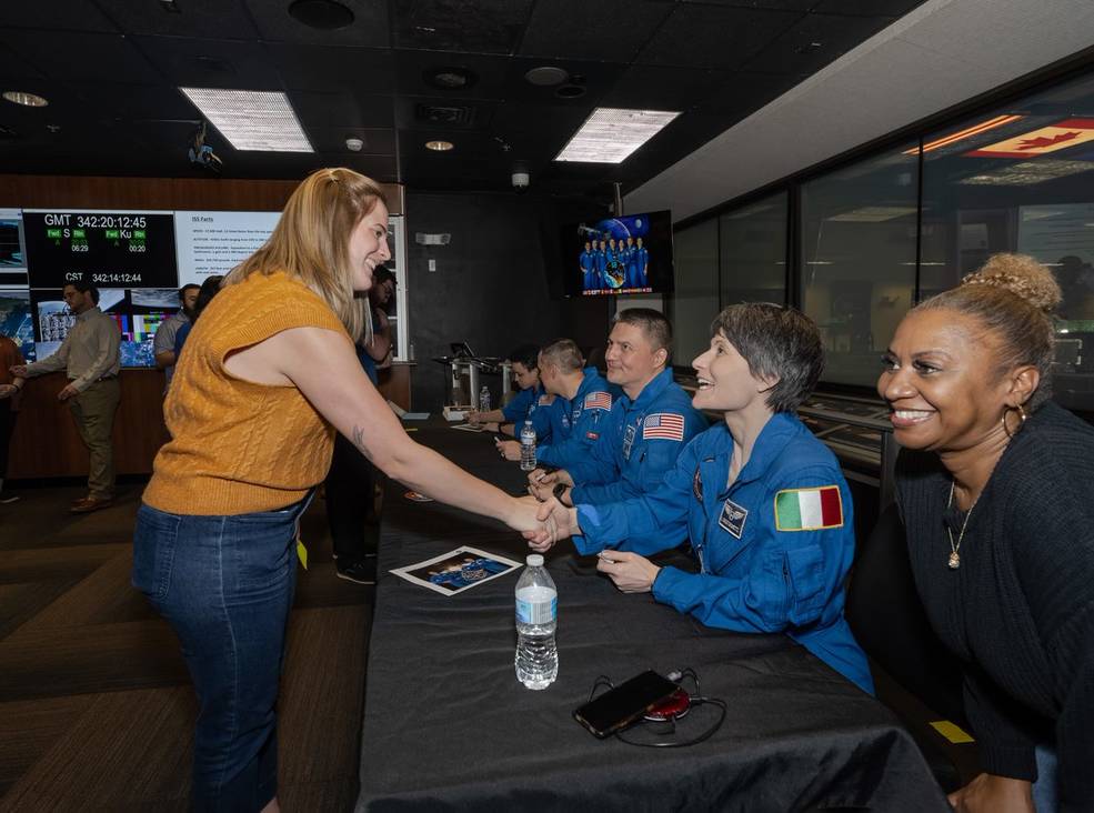Emma Robinson, a glovebox operator in payload and crew operations, greets ESA Astronaut Samantha Cristoforetti.