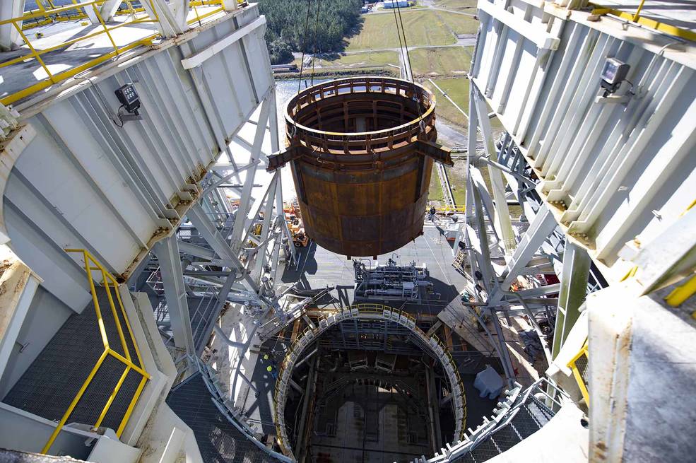 Crews at NASA's Stennis Space Center, near Bay St. Louis, Mississippi, lift the 75-ton interstage simulator test component into place at the B-2 Test Stand