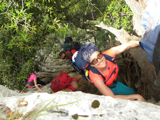 n her spare time, Elisabetta Cavazzuti, seen here among fellow fans of the outdoors, is climbing a steep cliff with rock climbing gear on including a helment.