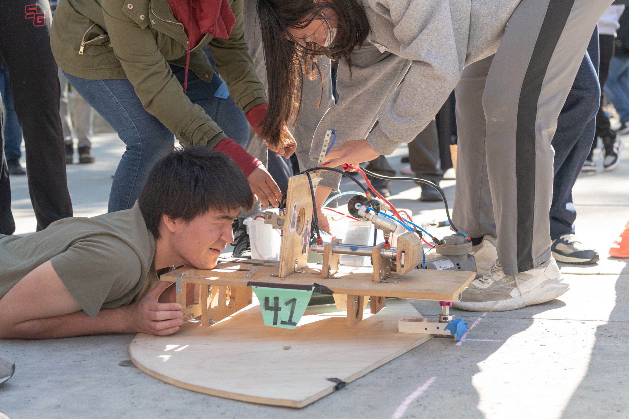 A student from Arcadia High School looks to align his team’s homemade device before competing at the JPL’s Invention Challenge.