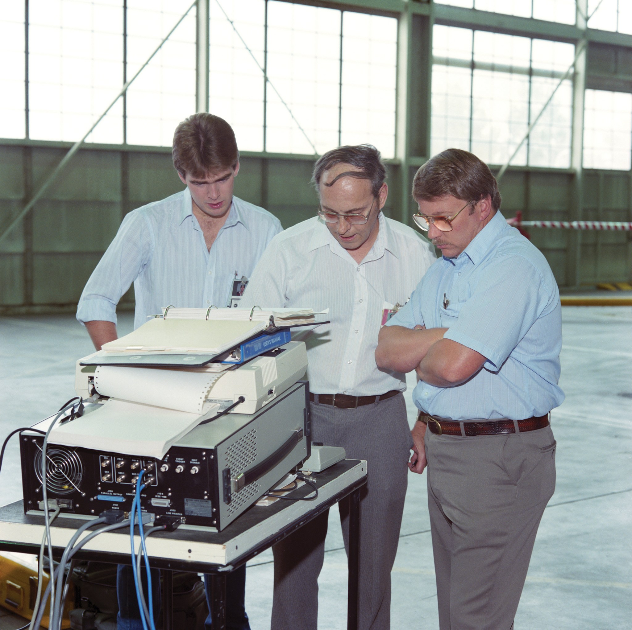 From left, Brad Flick, Dick Simon, and Jerry Henry analyze the aircraft data bus.
