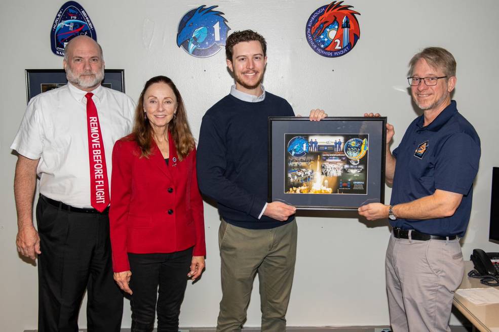 From left, Paul Crawford, Deborah Crane, Reid Ruggles and David Gwaltney present the Crew-1 mission plaque.