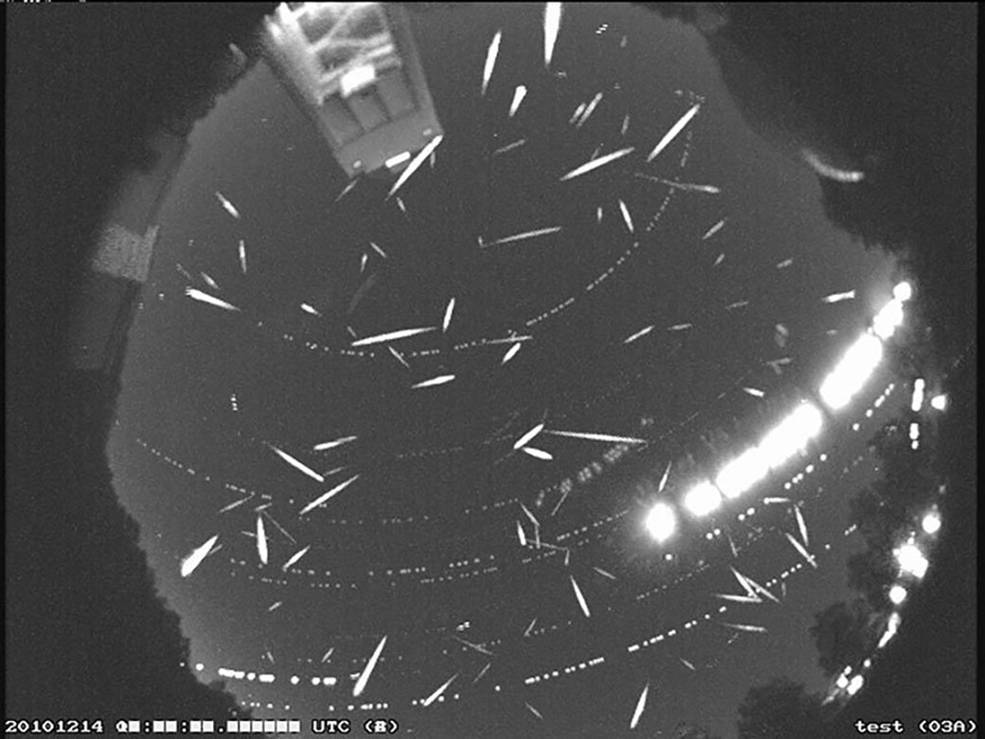 A circle shows several white streaks that represent more than 100 meteors during the peak of the Geminid meteor shower in 2014.