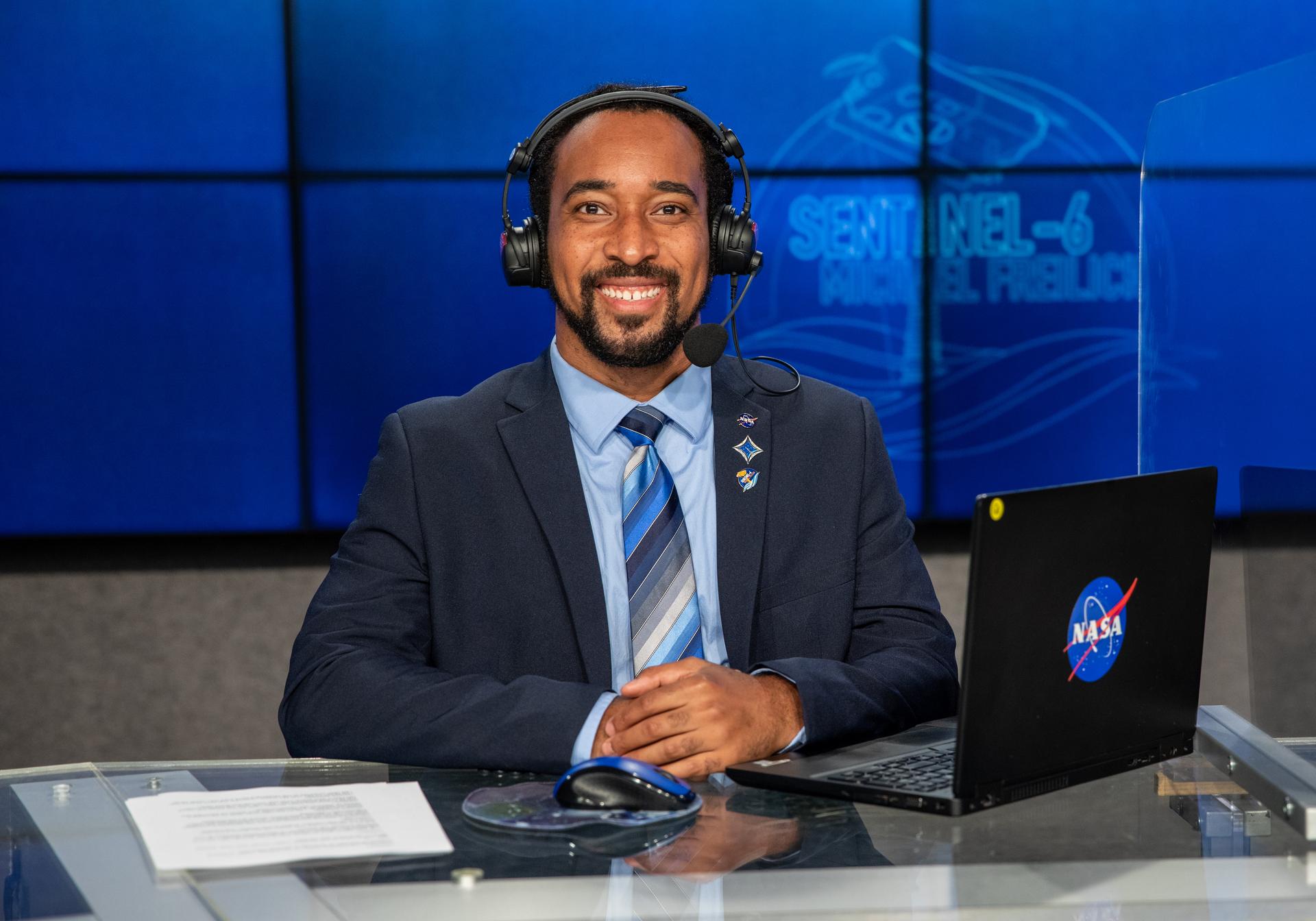 Portrait of Phillip Hargrove wearing a headset as he takes part in coverage for the Sentinel 6 launch