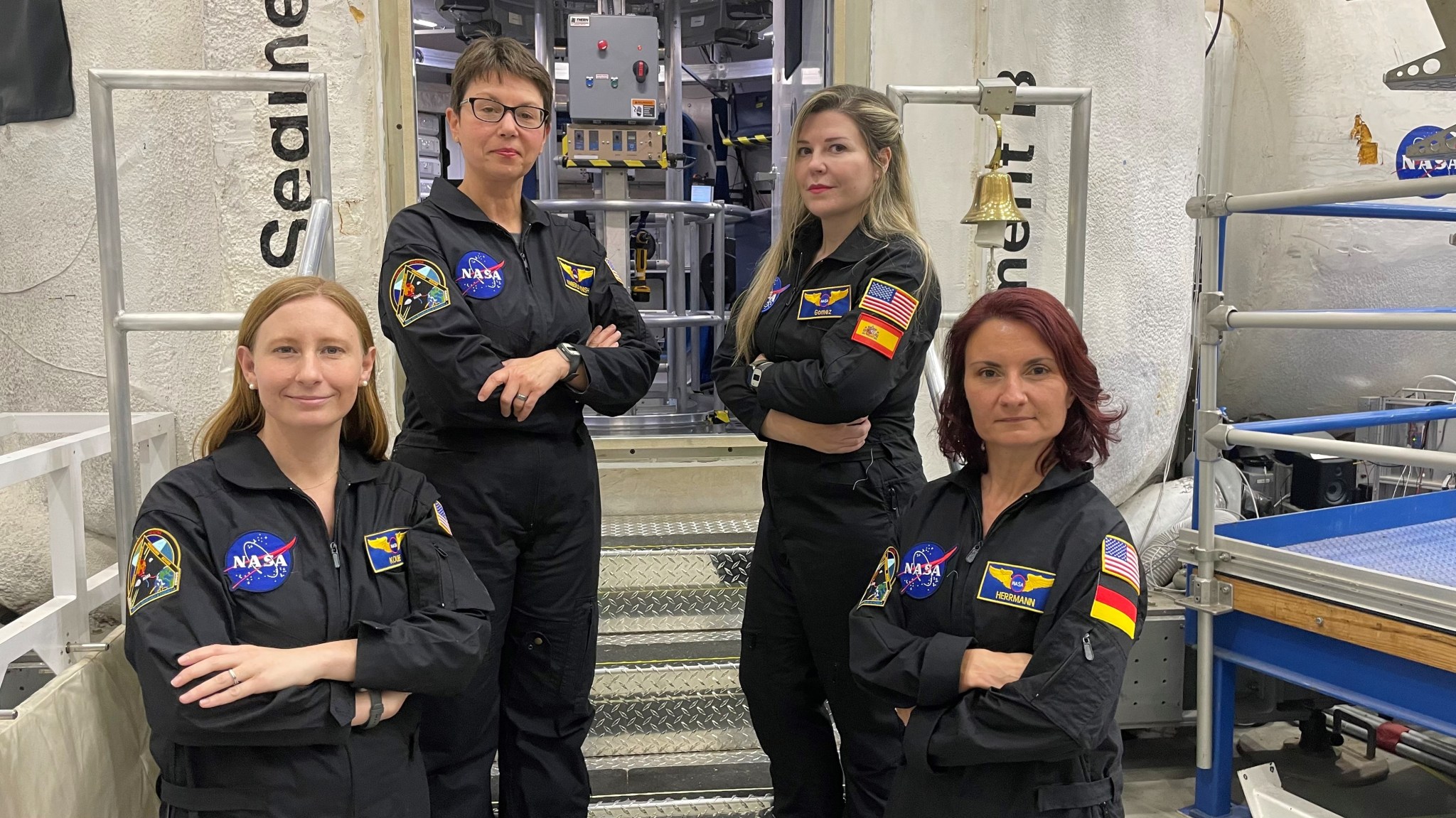 The crew for the next mission of NASA's Human Exploration Research Analog, or HERA, stand outside the HERA habitat  Pictured from left to right: Katie Koube, Kimberly Knish, Vanesa Gomez Gonzales, and Sandra Herrmann.