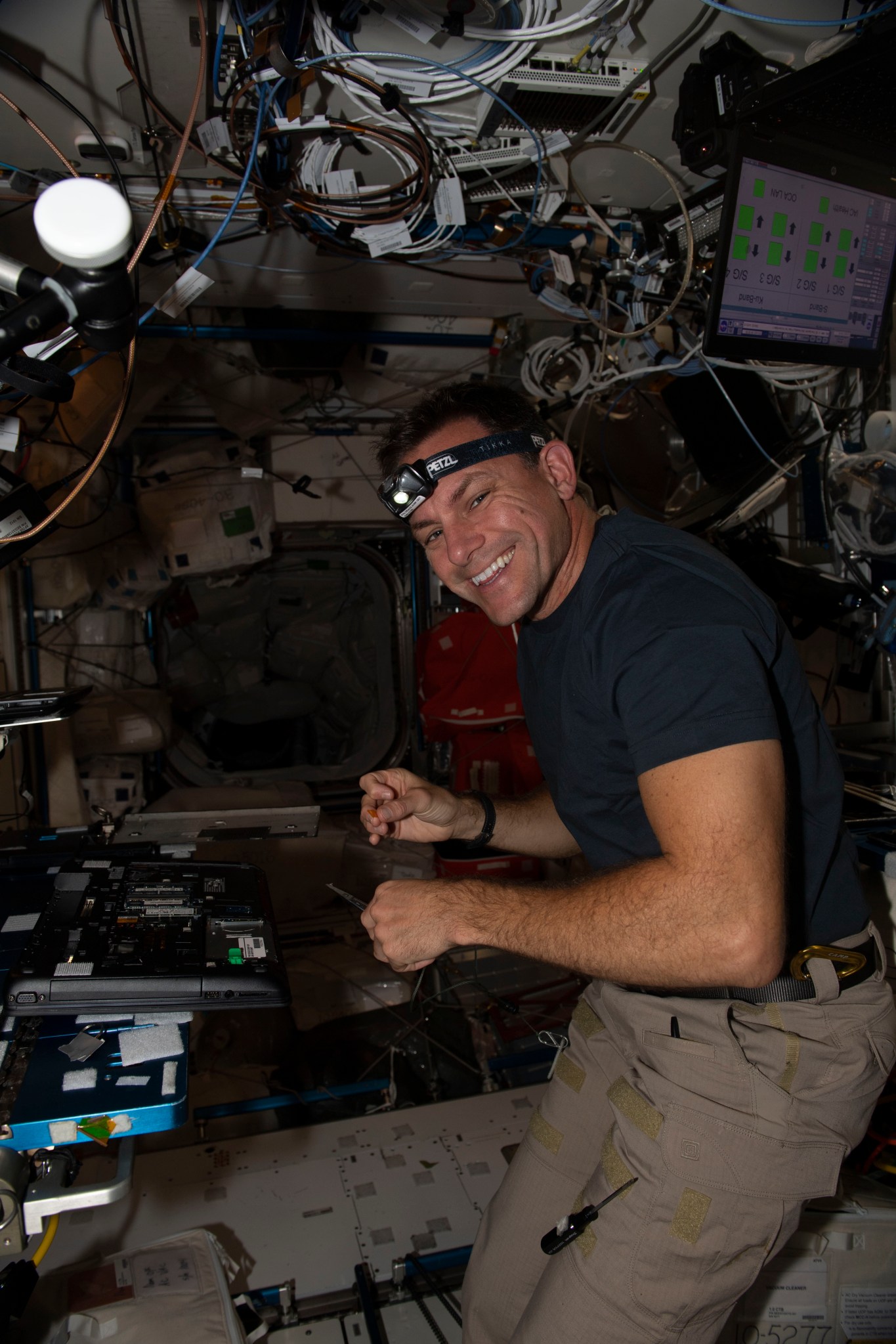 (Oct. 25, 2022) u002du002d- NASA astronaut and Expedition 68 Flight Engineer Josh Cassada performs laptop computer maintenance inside the International Space Station's Harmony module.