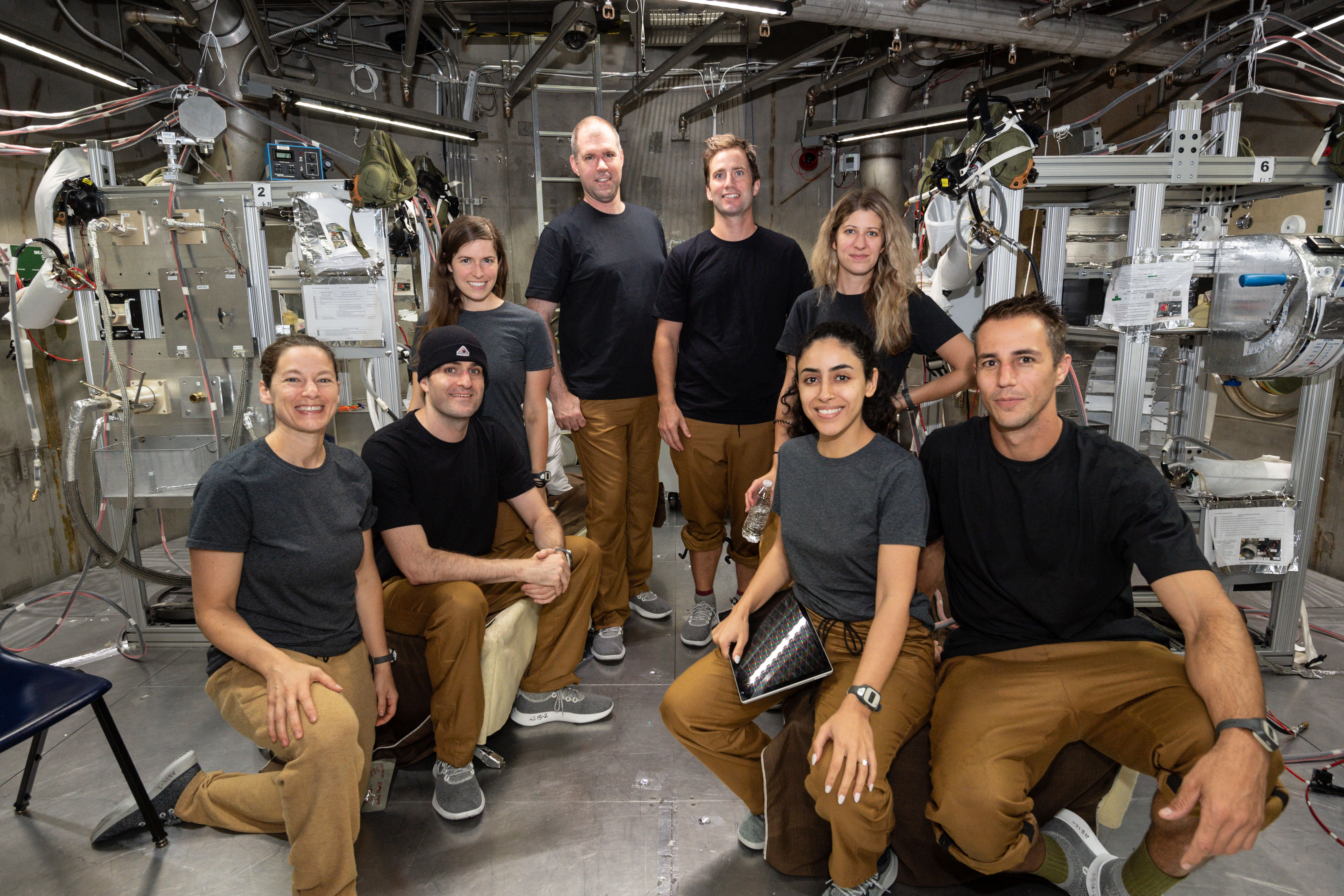 Th test participants of the 20-Foot Chamber 11-Day Manned Reduced Pressure Prebreathe Protocol Test pose for a group photo prior to egress on June 17, 2022.