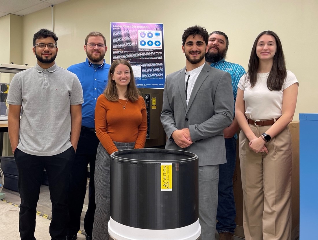 NASA’s early-career Lunar Dust Distributor team poses with the device at NASA Johnson in Houston.