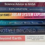 Stack of NASA History books including Science Advice to NASA, Emblems of Exploration, 50 Years of Solar System Exploration, Origins of 21st-Century Space Travel, Not Yet Imagined and Beyond Earth.
