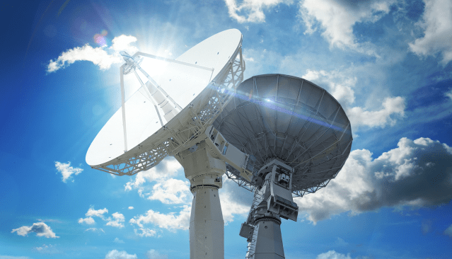 Antennas against blue sky with clouds