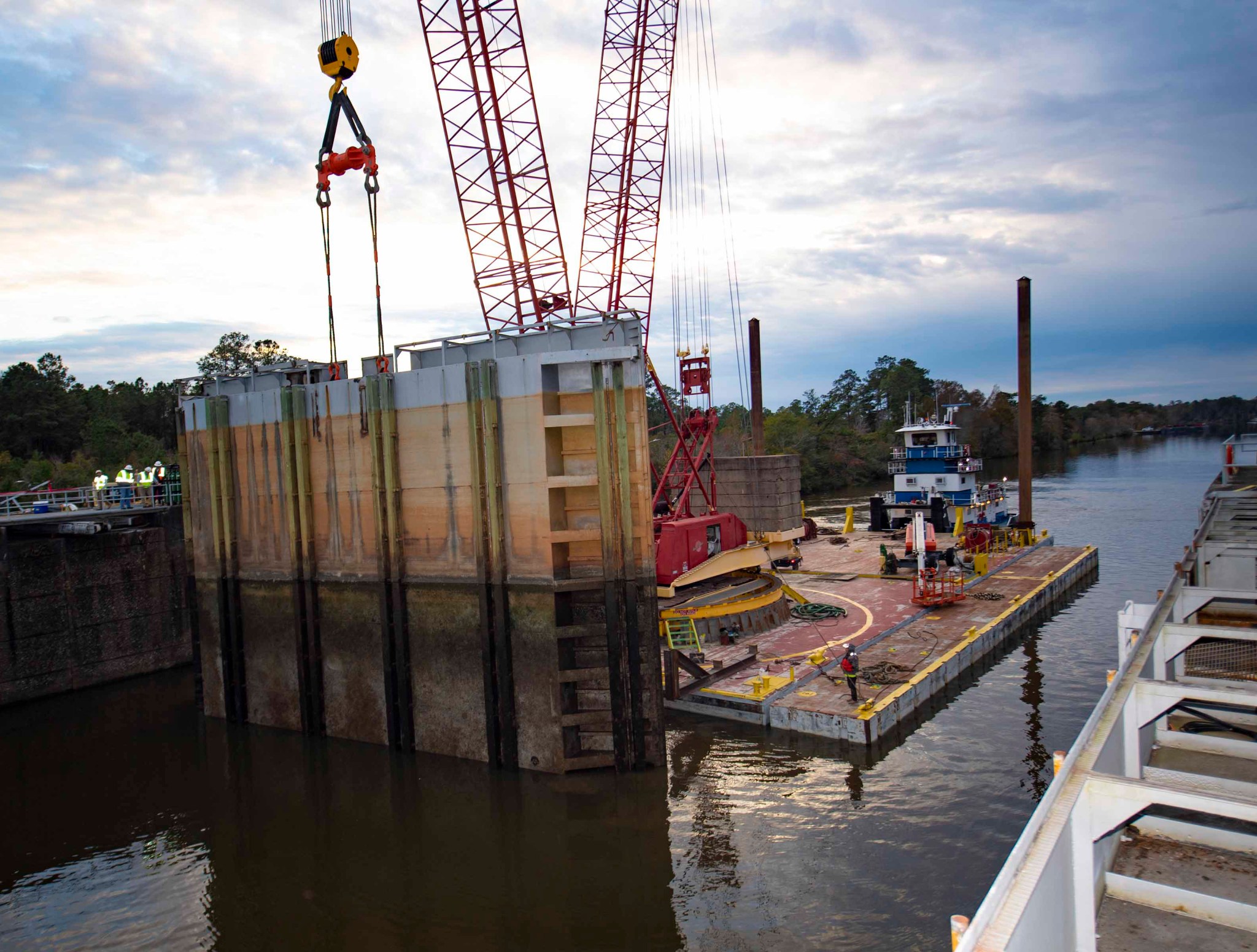 Crews use a crane on a floating barge to lift the lower south gate of the navigation lock system at NASA’s Stennis Space Center