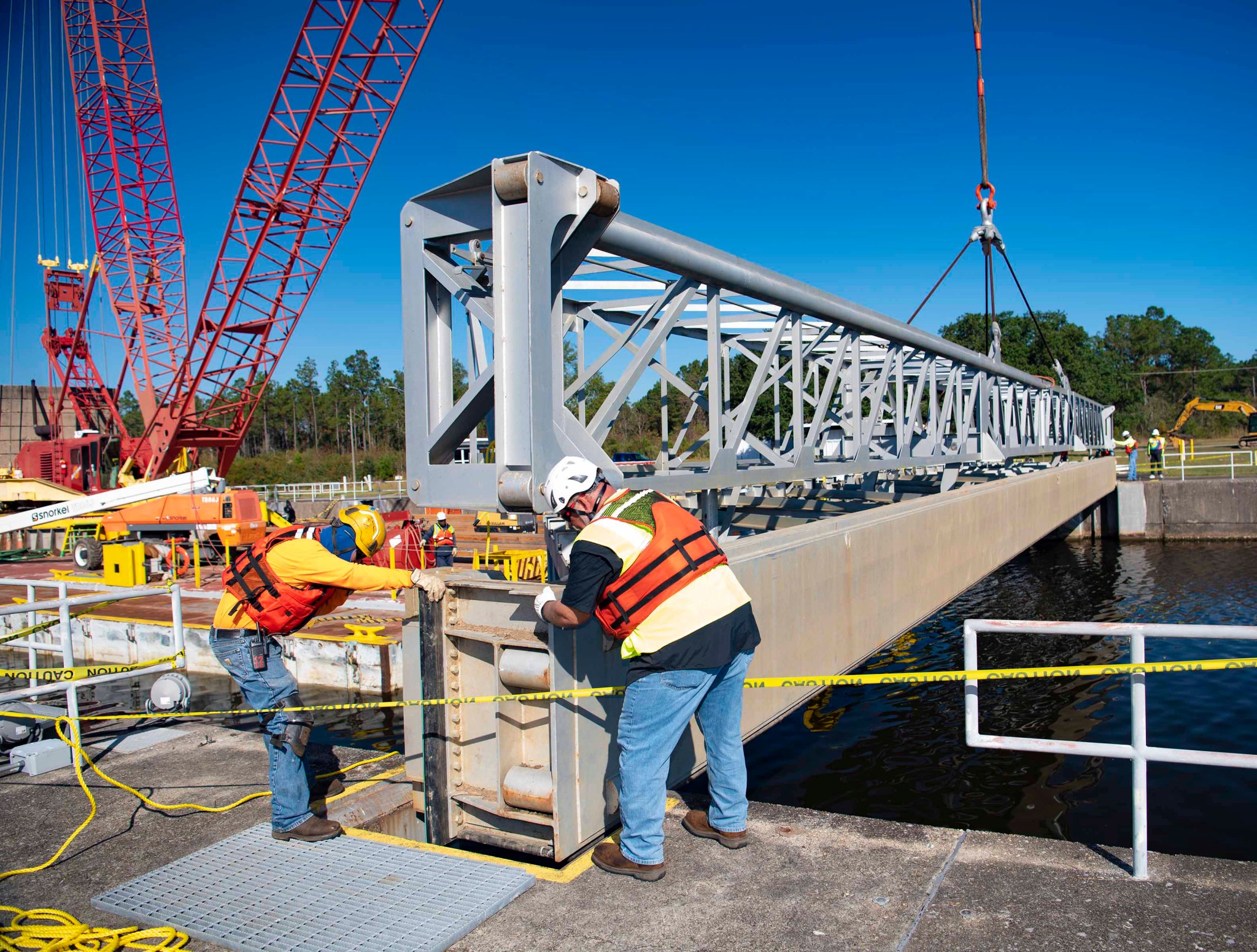 Crews position temporary detainer walls, known as stop logs, to ensure the seven-and-a-half-mile canal system that connects NASA’s Stennis Space Center to the Pearl River will maintain the proper water level 