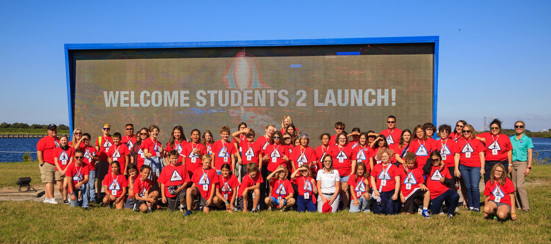 A group of students and their chaperones gather for a photo at the launch countdown clock near the News Center at NASA’s Kennedy Space Center in Florida on Oct. 6, 2022. 