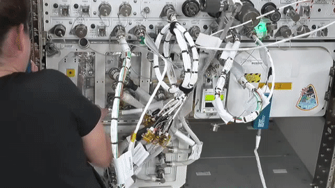 video of an astronaut working on experiment hardware