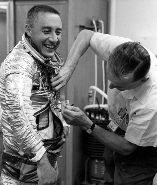 Project Mercury Astronaut Virgil I. Grissom is assisted by suit specialist Joe W. Schmidt as he prepares for his Mercury-Redstone 4 space flight