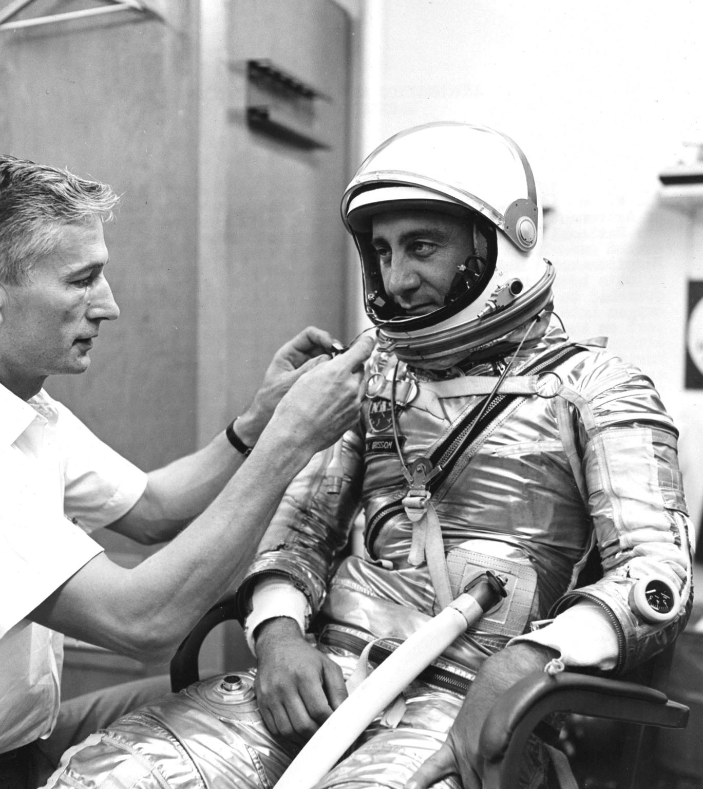 Project Mercury pressure suit specialist Joseph W. Schmitt adjusts a respirometer attached to the helmet of astronaut Virgil I. Grissom during a dress rehearsal for the second manned suborbital flight, dubbed Liberty Bell 7.
